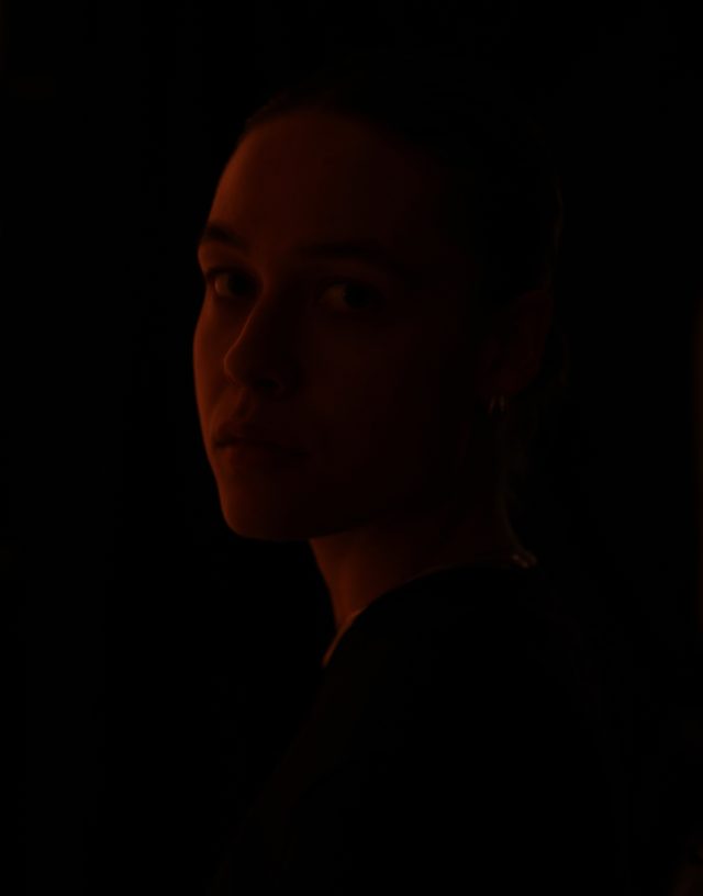 a woman in a dark room