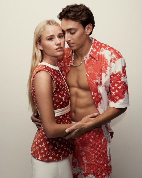 a man and woman in matching outfits