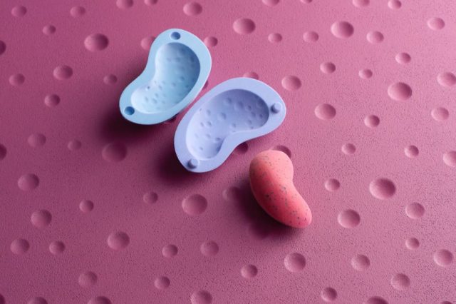 a pink and blue rubber molds on a pink surface