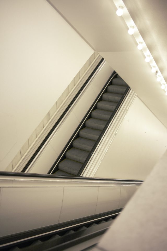 an escalator going down a building