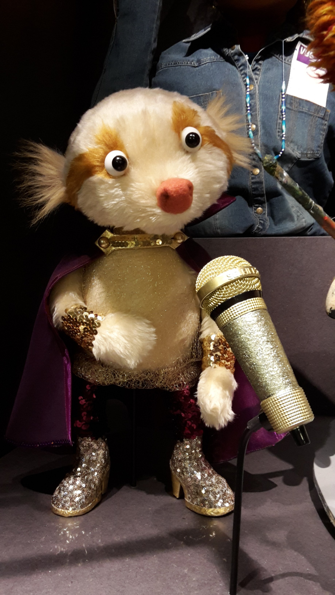 a stuffed animal holding a microphone