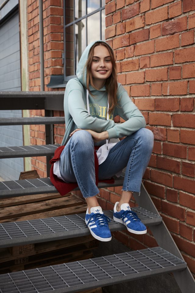 a woman sitting on a metal staircase