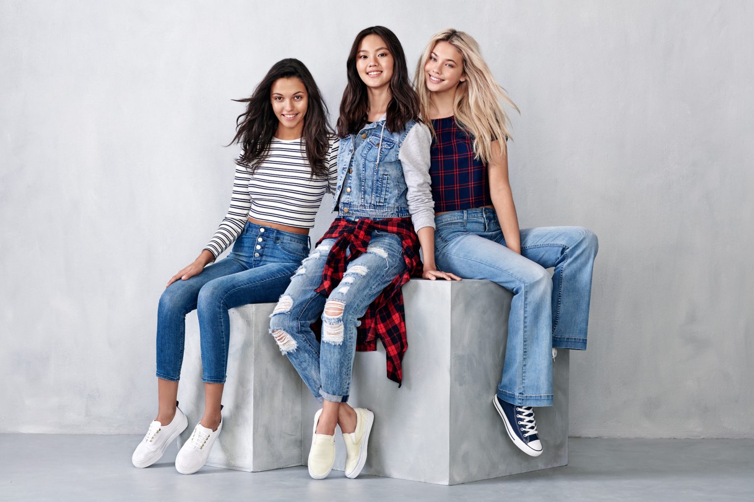 a group of women sitting on a cube