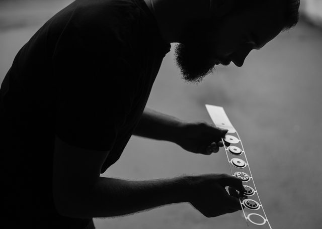 a man holding a piece of paper with buttons