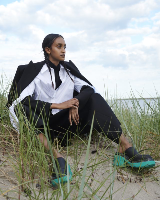 a woman sitting in the grass