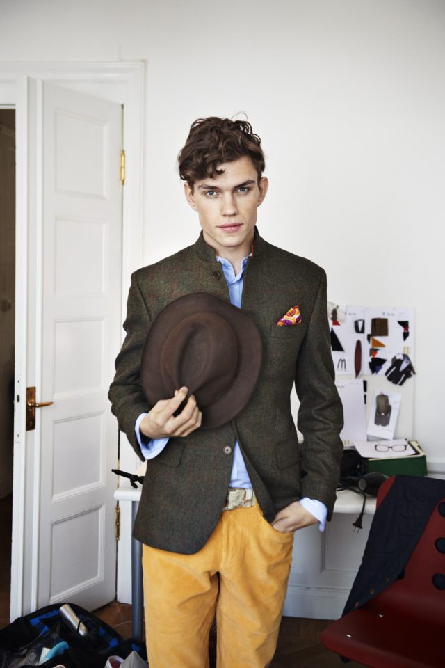 a man holding a hat