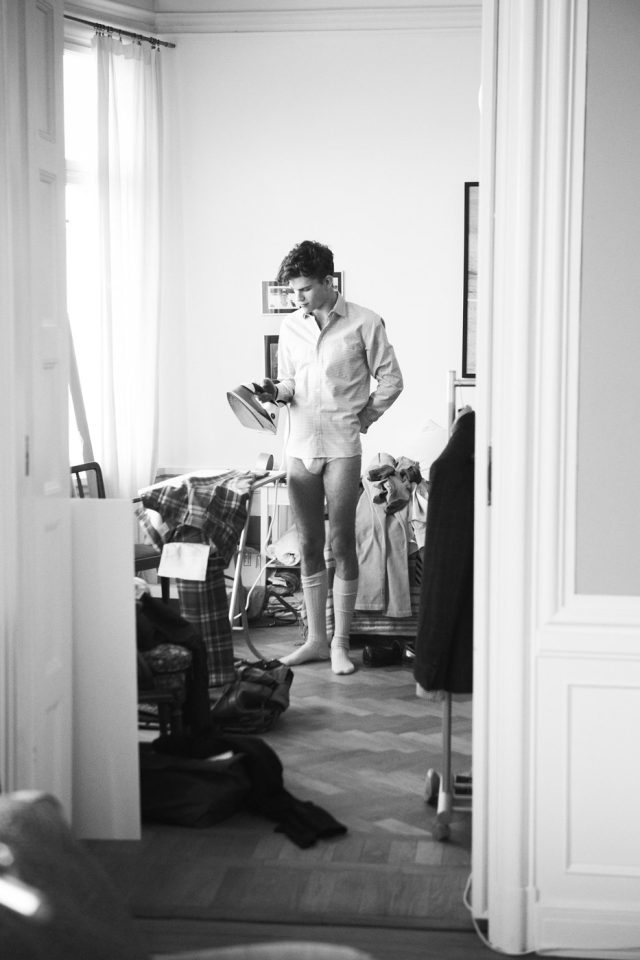 a man in underwear holding an iron