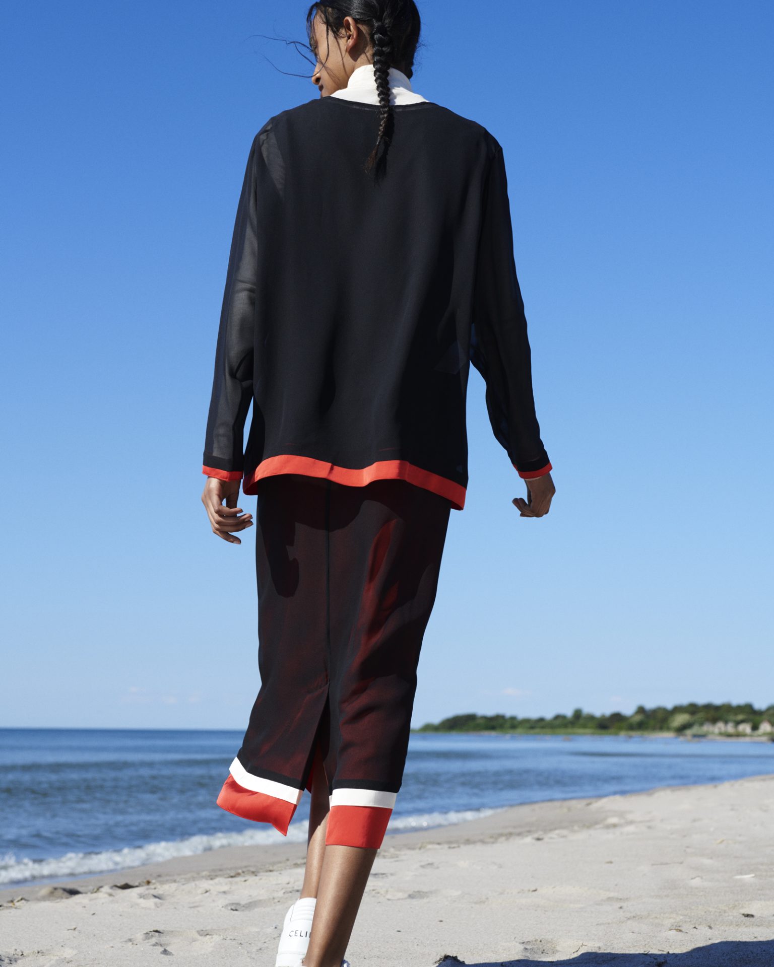 a woman walking on a beach