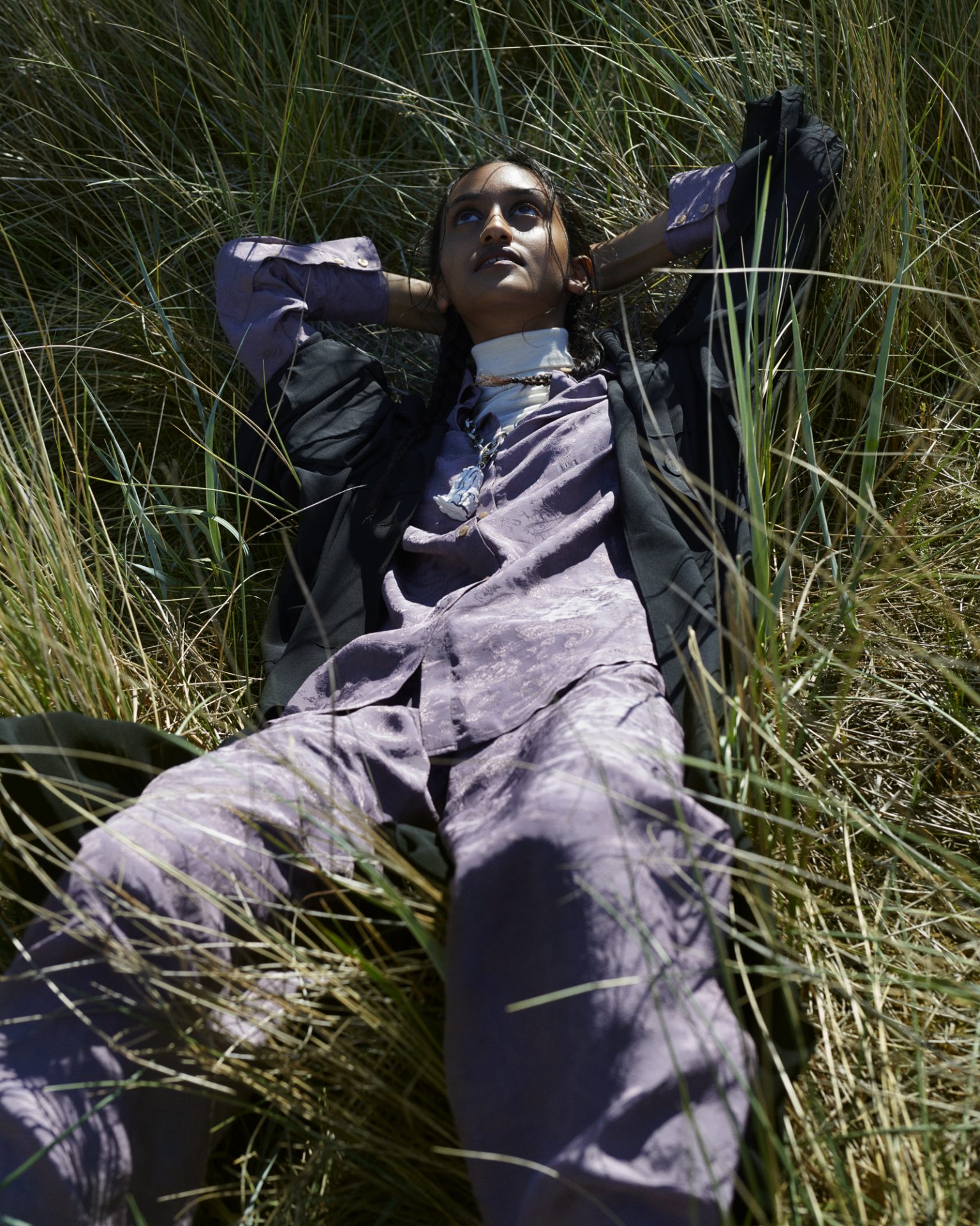 a woman lying in tall grass