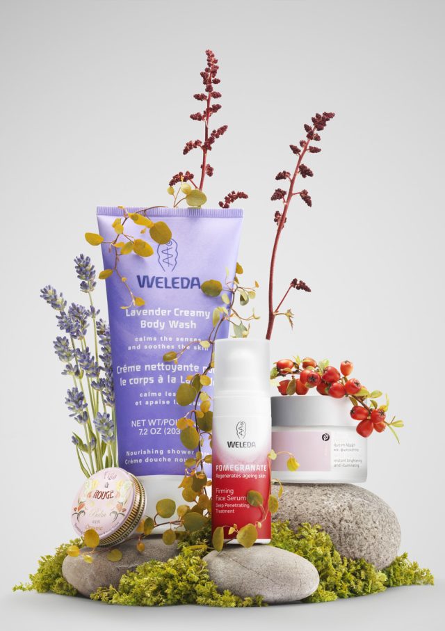 a group of body wash containers and flowers