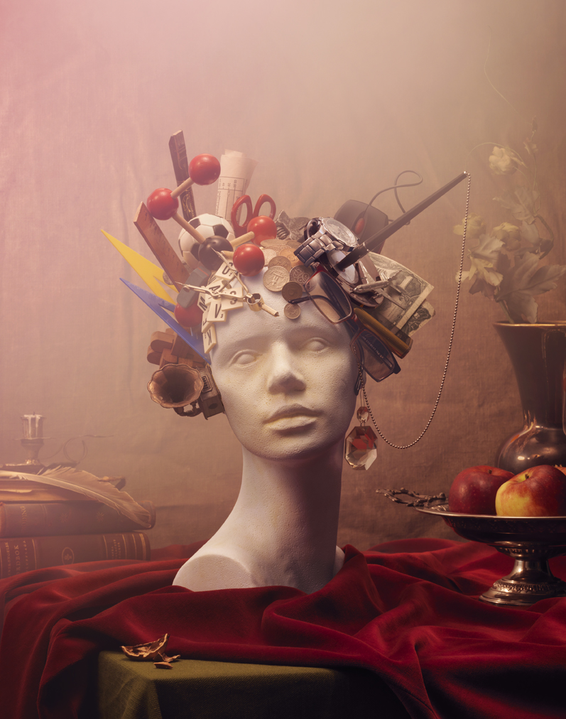 a sculpture of a woman with objects on her head