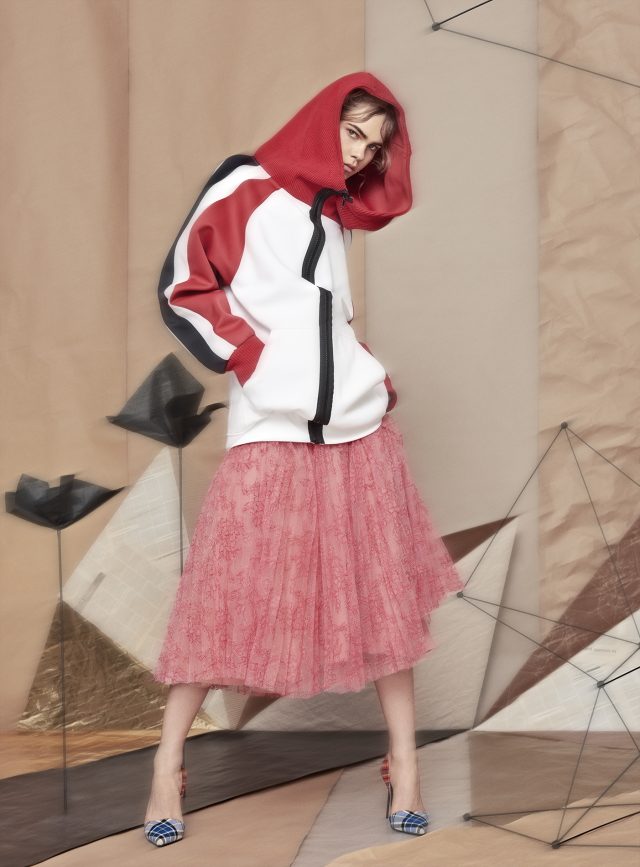 a woman in a pink skirt and a jacket