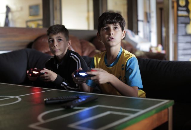 two boys playing video games