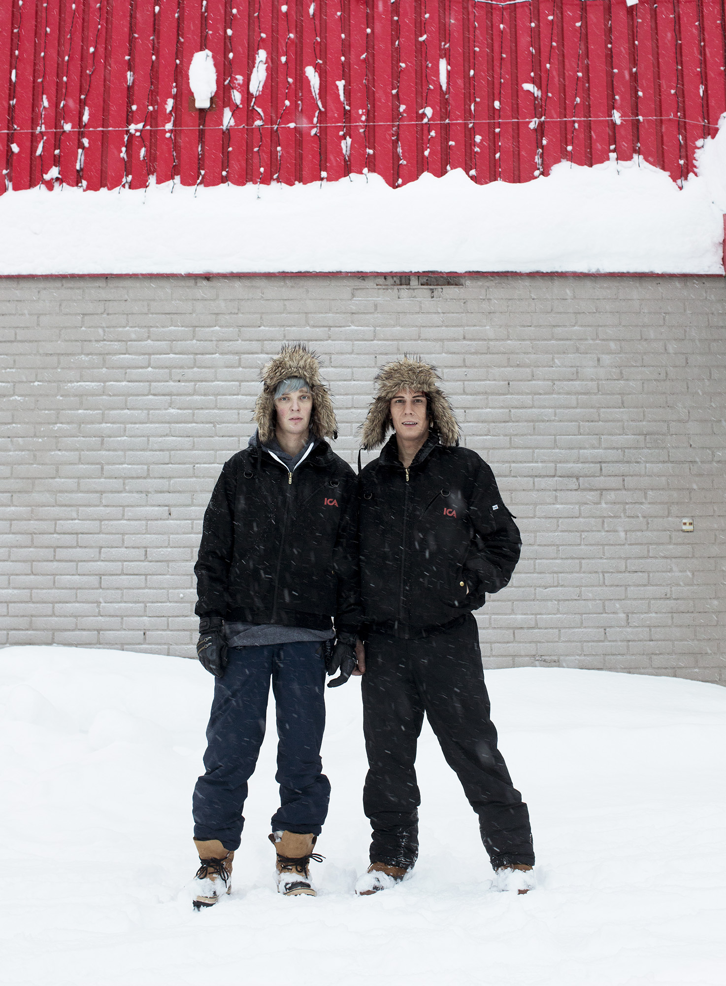 two men wearing skis and snow boots