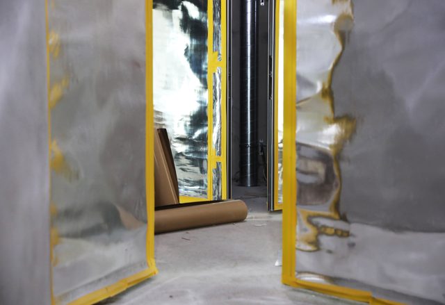 a room with a yellow and silver wall