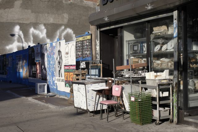 a storefront with signs and chairs
