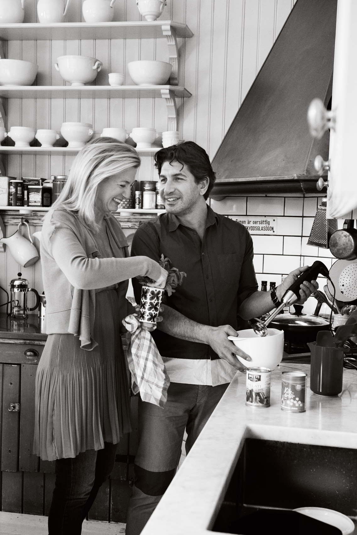 a man and woman in a kitchen
