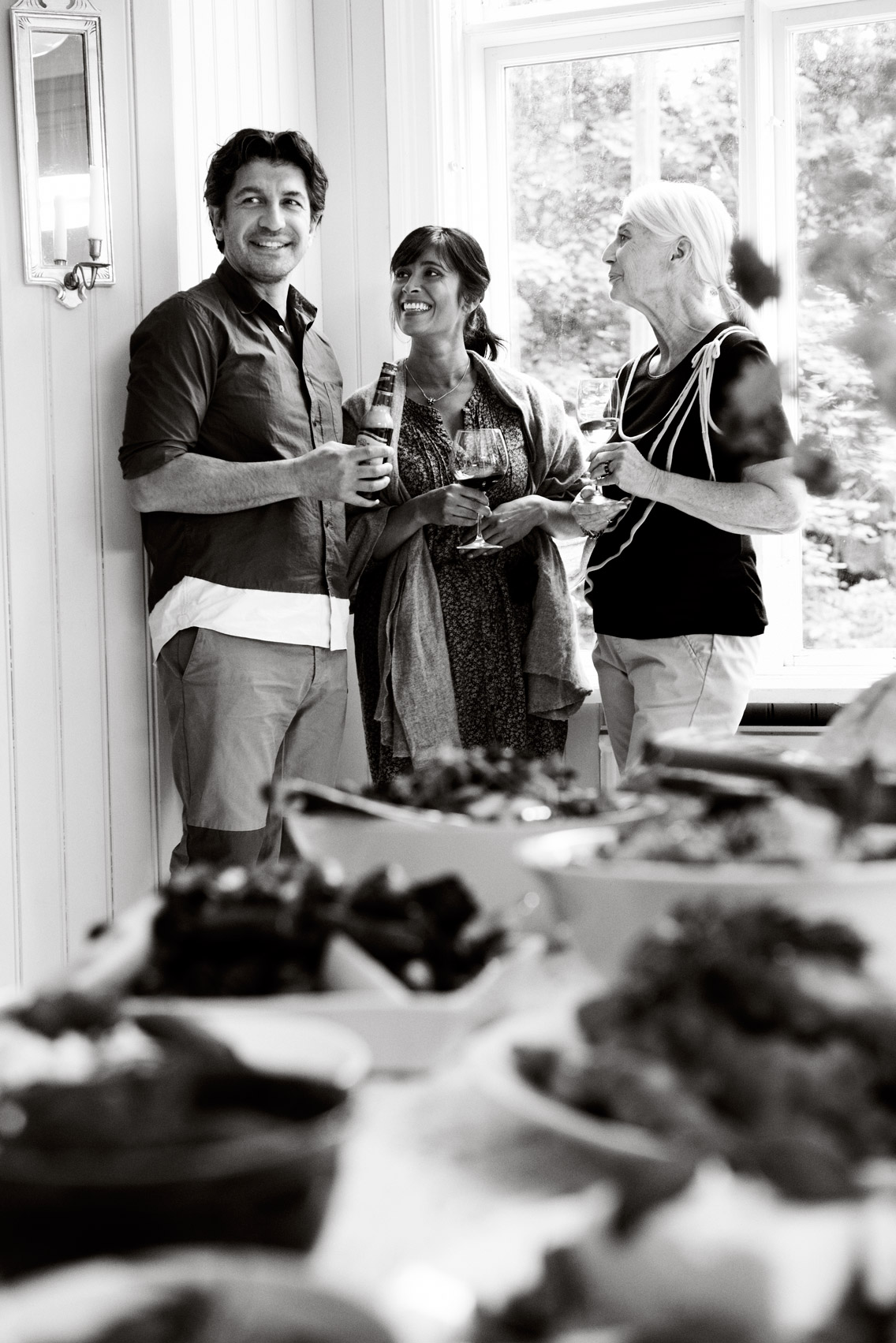 a group of people standing together and drinking wine