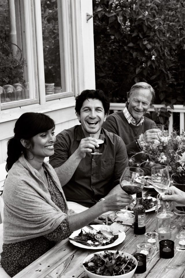 a group of people sitting at a table with wine glasses