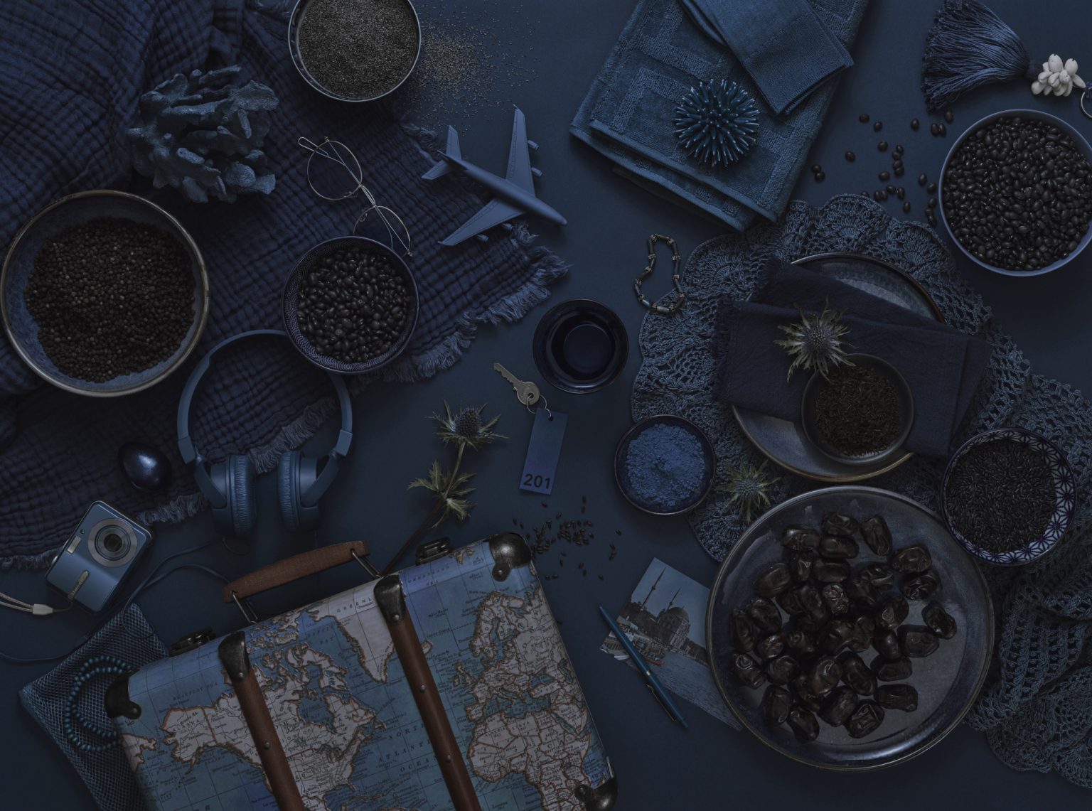 a blue table with a suitcase and objects