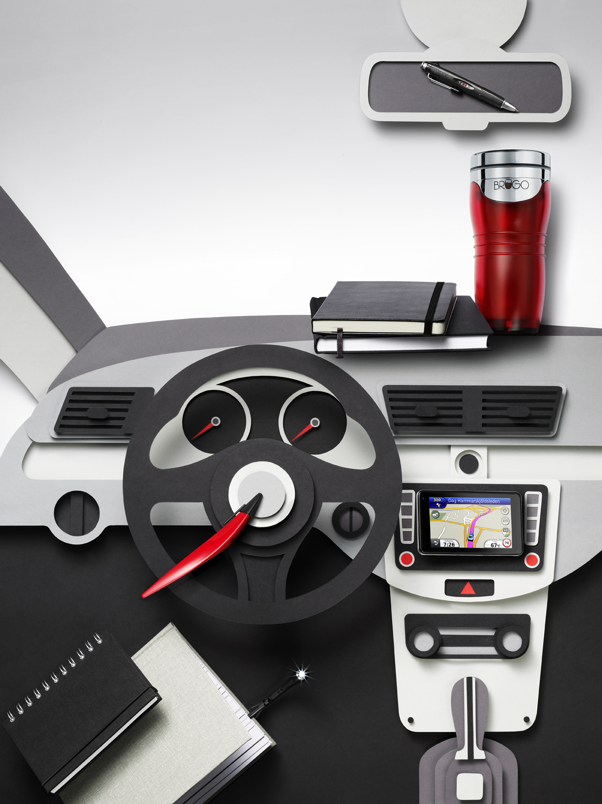 a car steering wheel with a red cup and a red mug