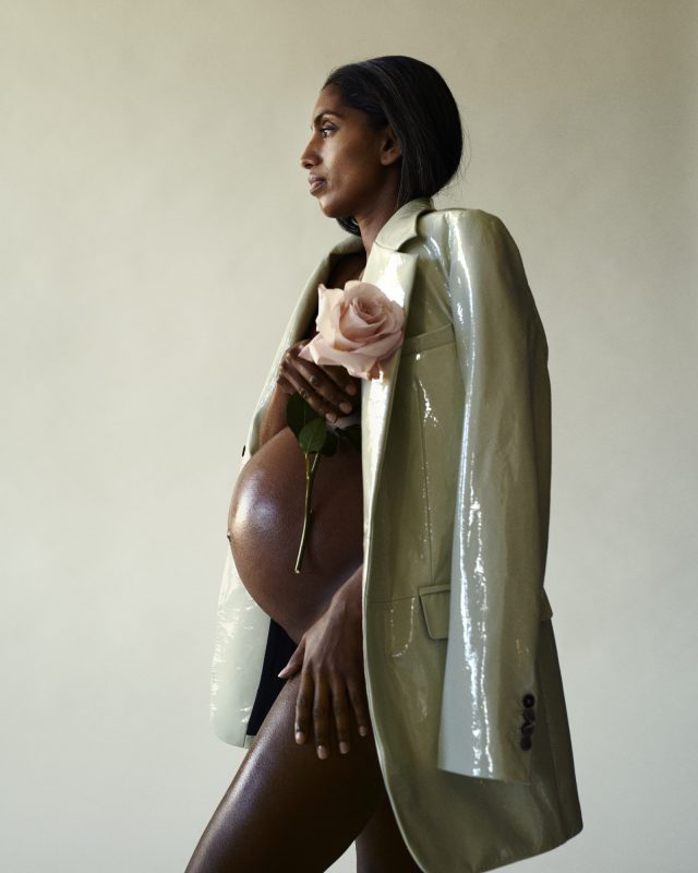 a pregnant woman holding a rose