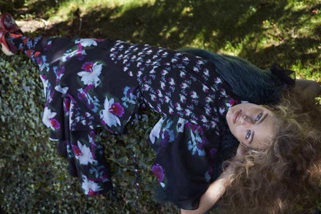 a woman lying on a fur pillow