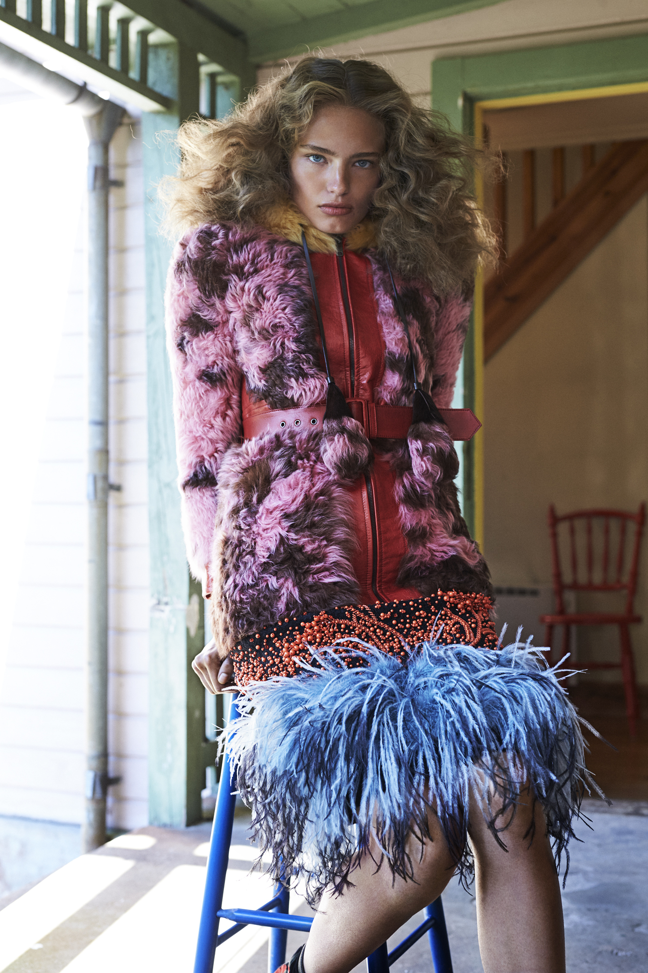 a woman in a pink and black fur coat