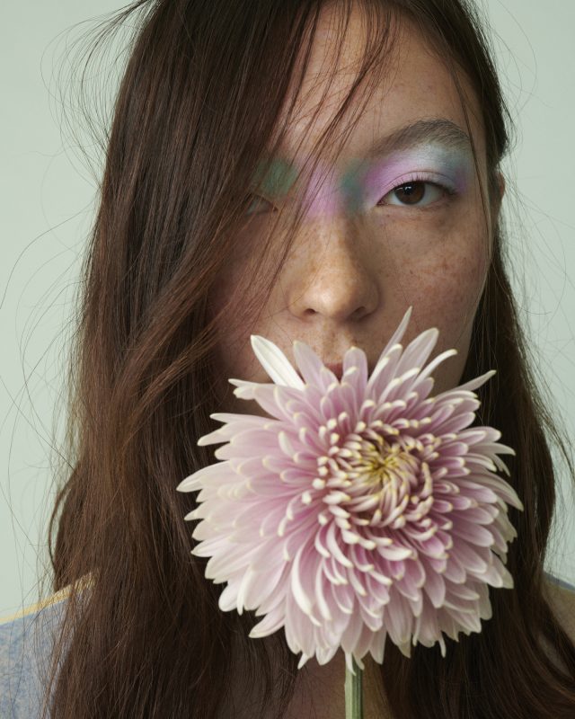 a woman holding a flower