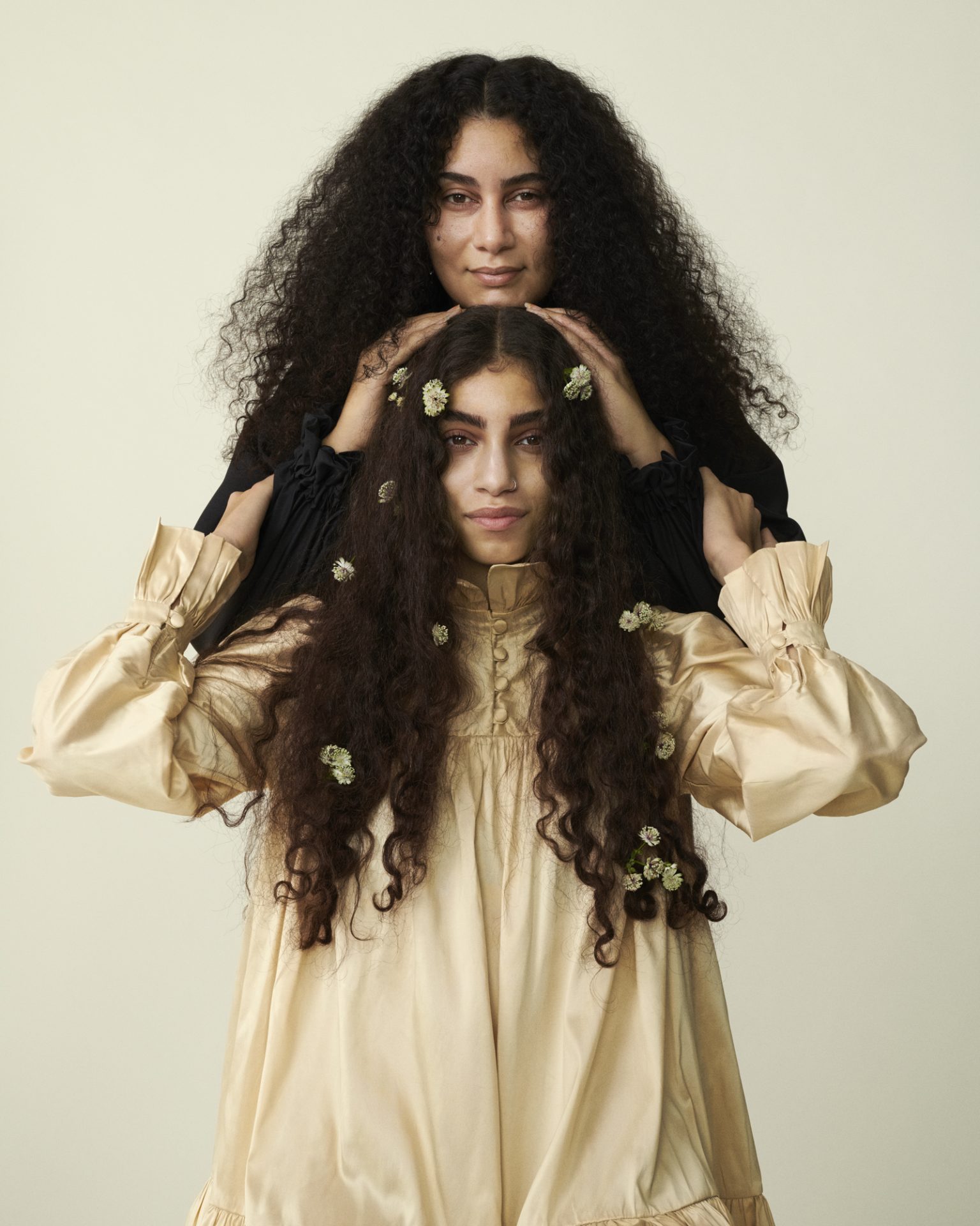 two women with long curly hair