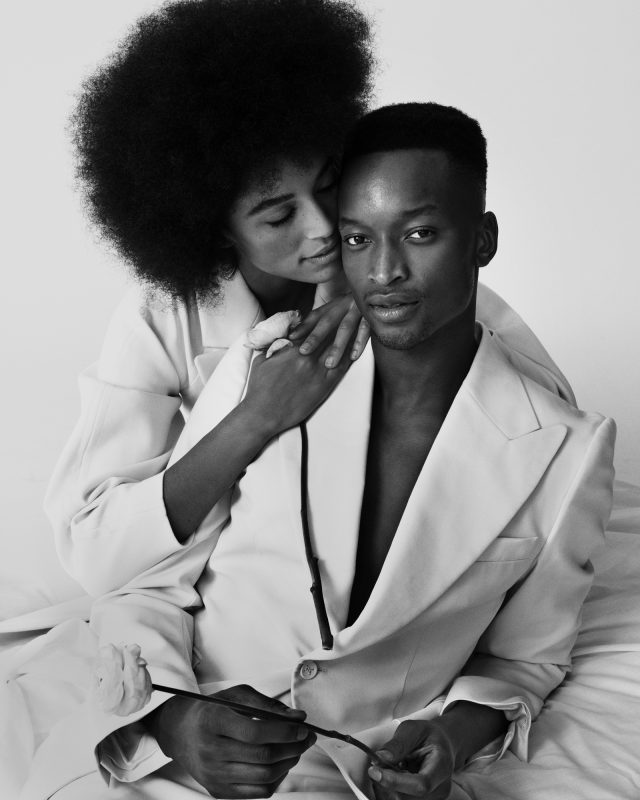 a woman holding a man's shoulder