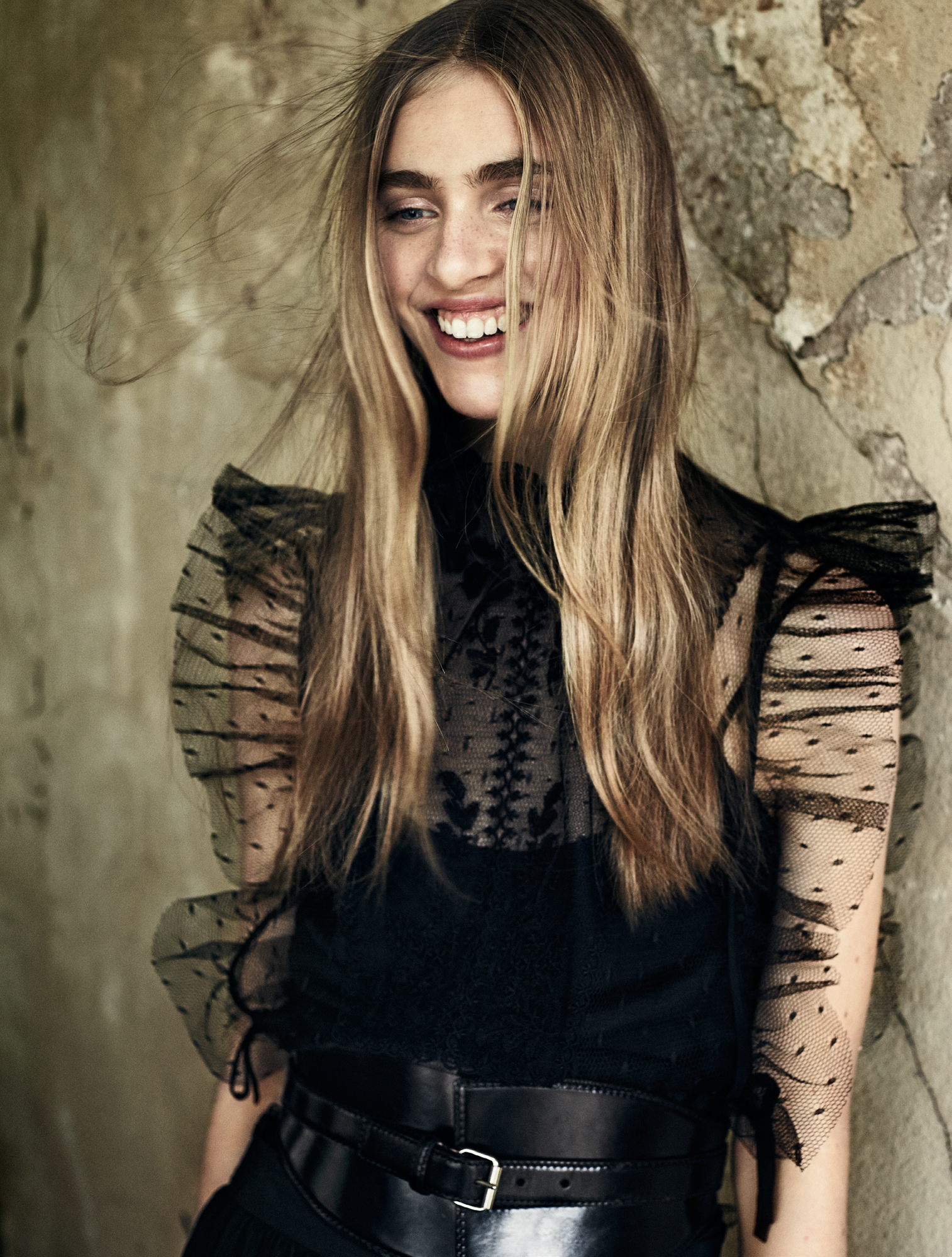 a woman smiling in a black dress
