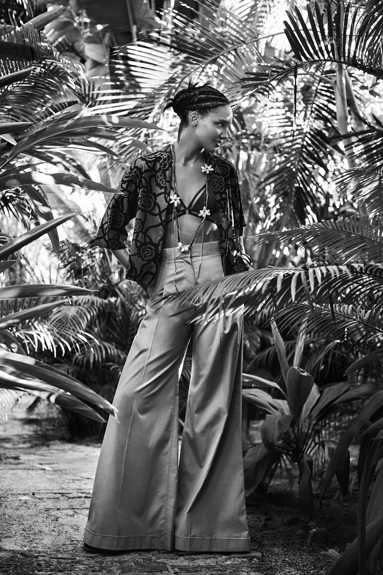 a woman standing in a jungle