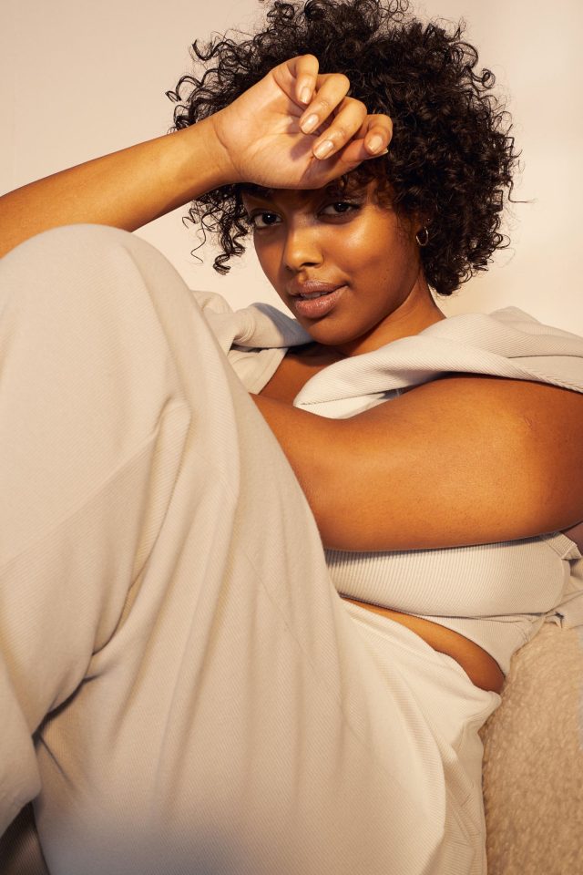 a woman lying down with her hand on her forehead