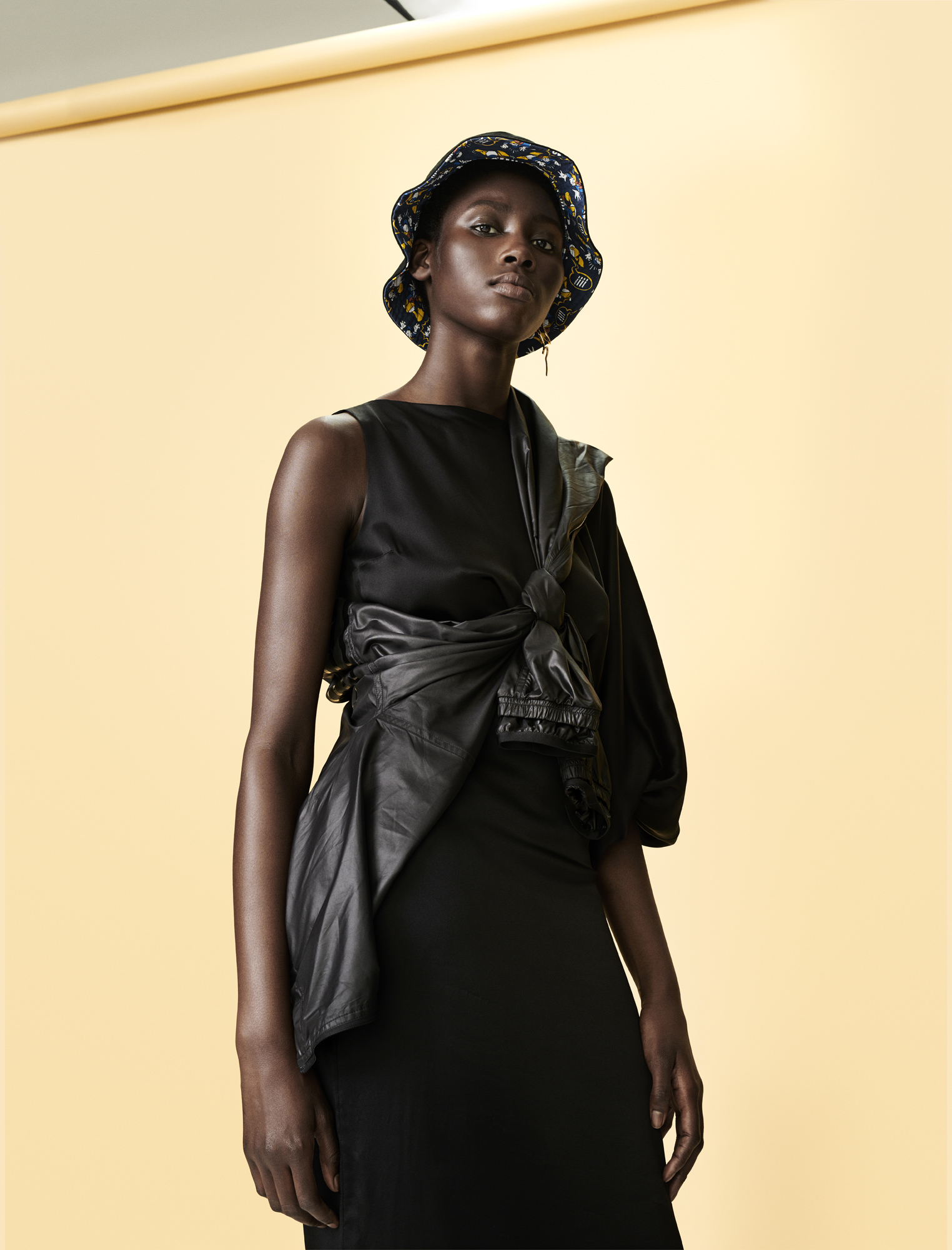 a woman in a black dress and hat