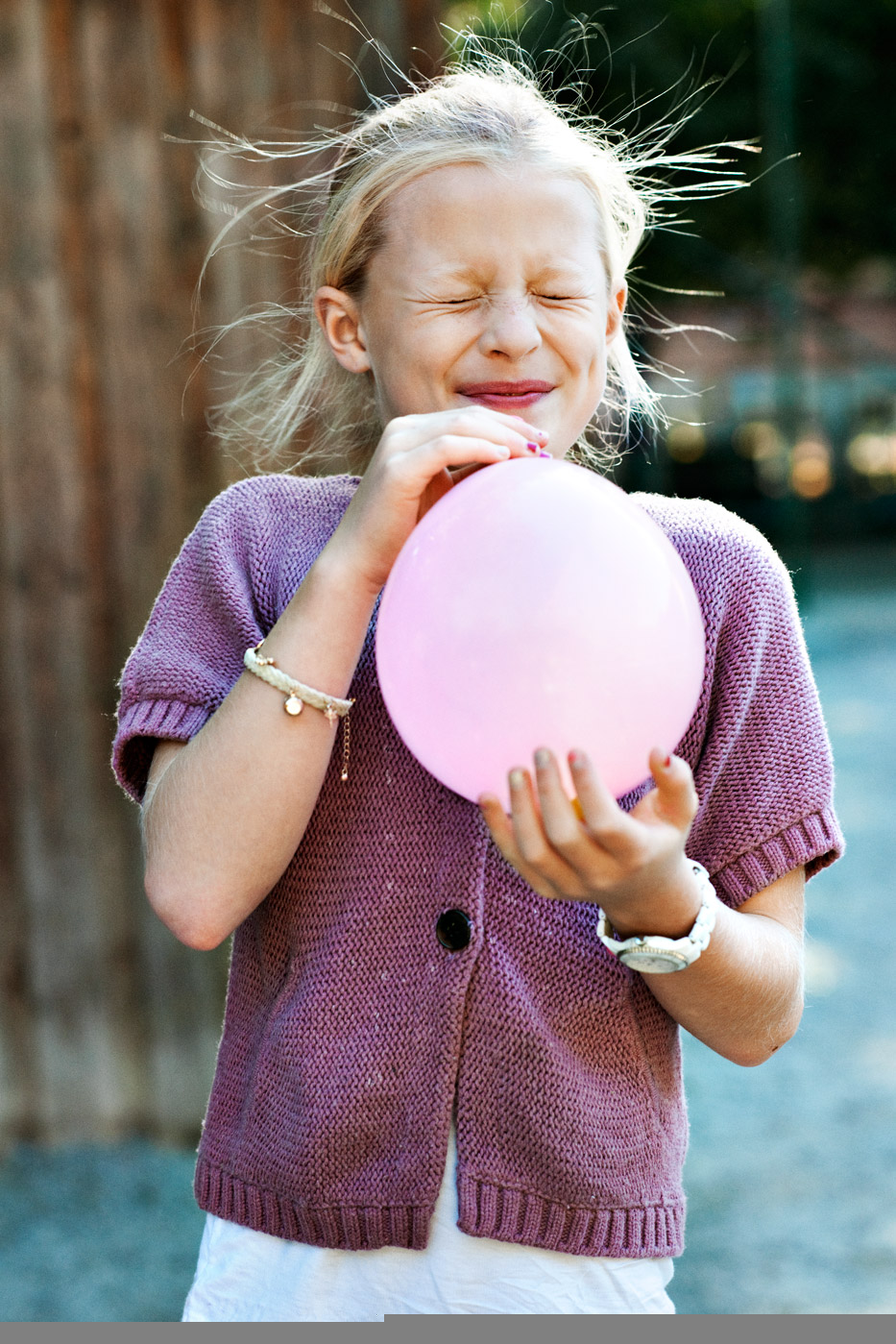 a girl holding a balloon