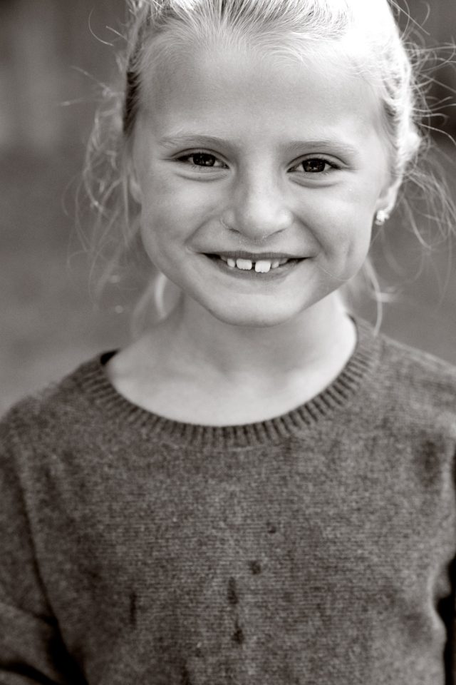 a close-up of a girl smiling