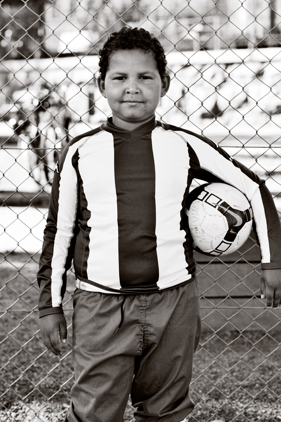 a boy holding a football ball