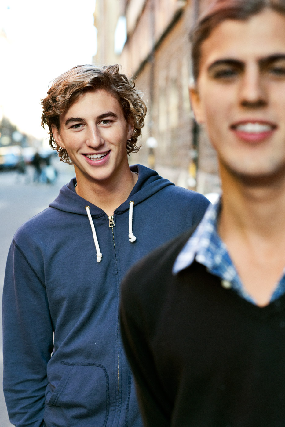 a couple of young men smiling