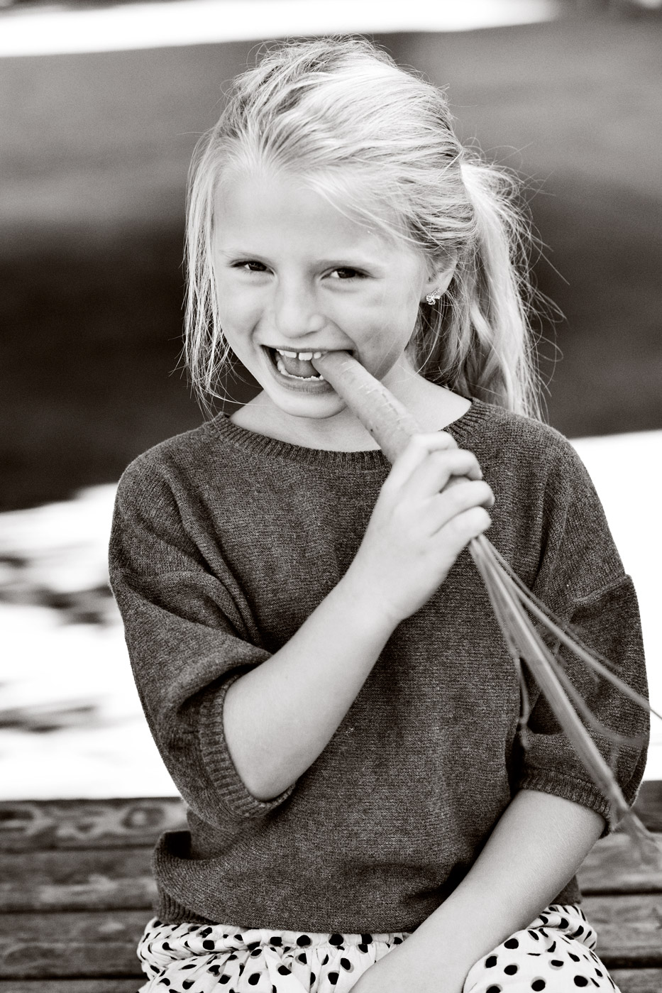 a girl eating a carrot