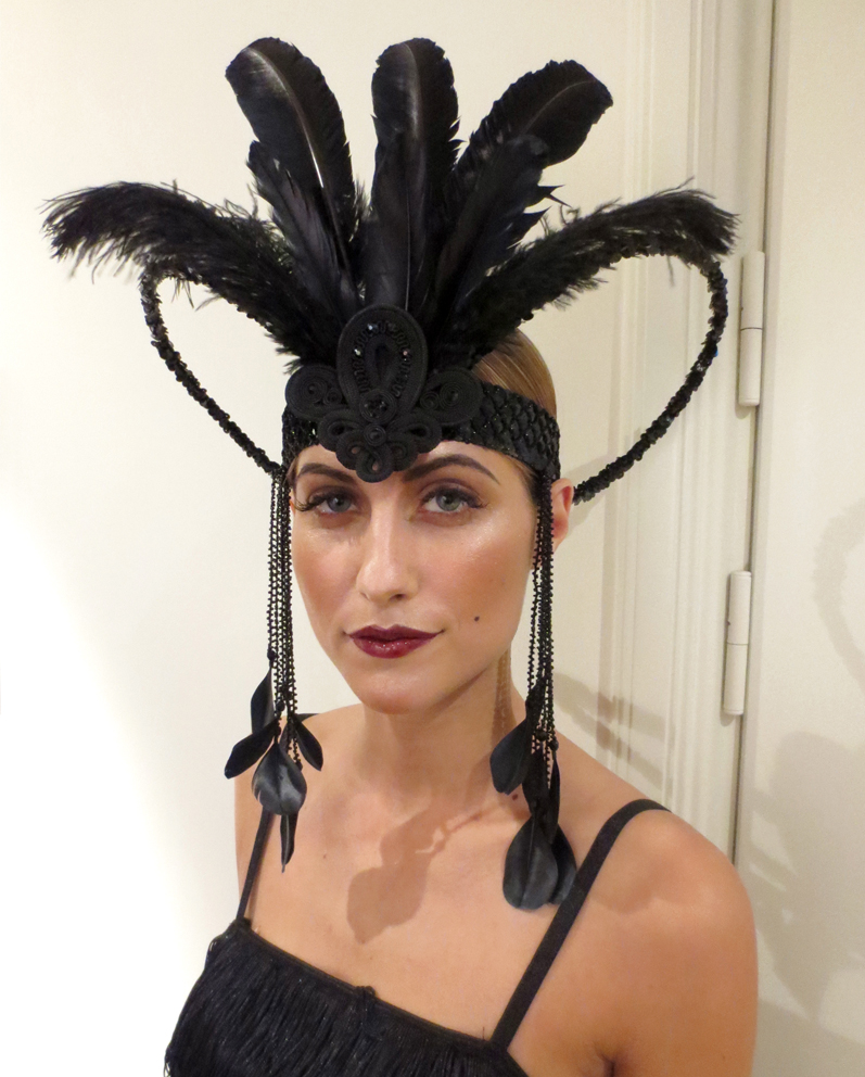 a woman wearing a black feather headpiece