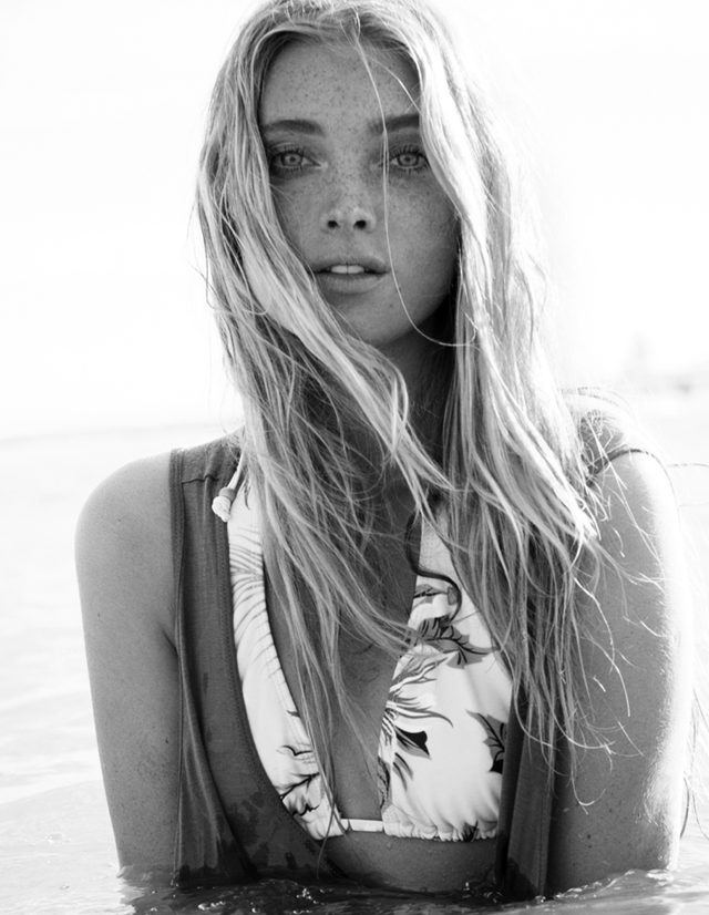 a woman with long hair and freckles