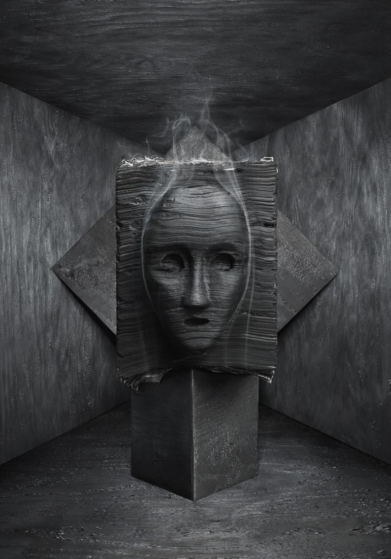a sculpture of a face with smoke coming out of it