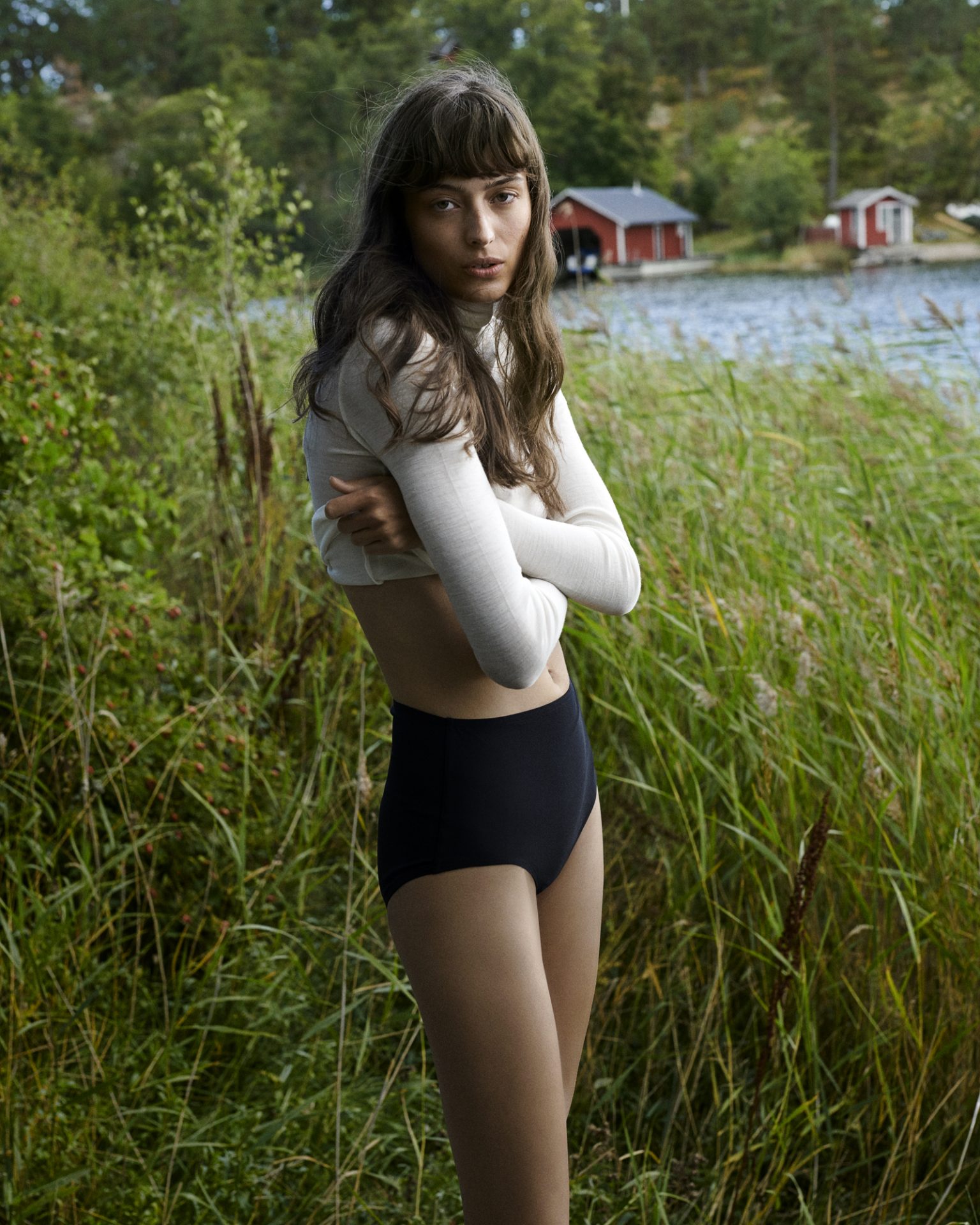 a woman standing in a grassy area
