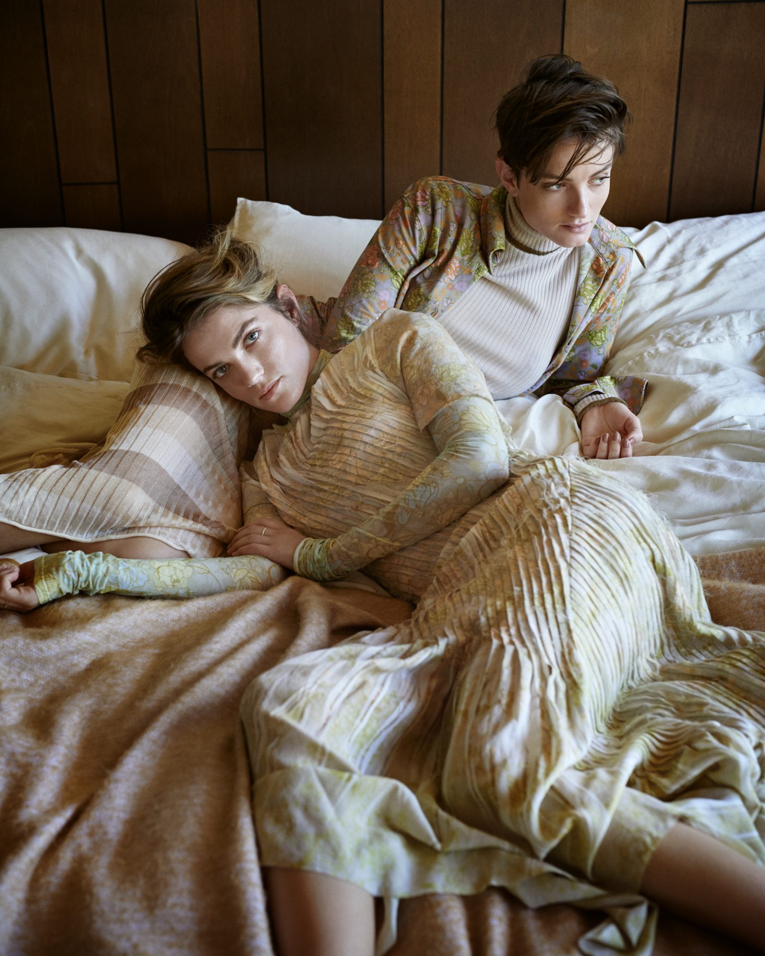 two women lying on a bed
