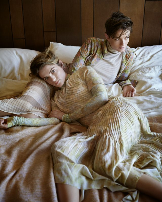 two women lying on a bed