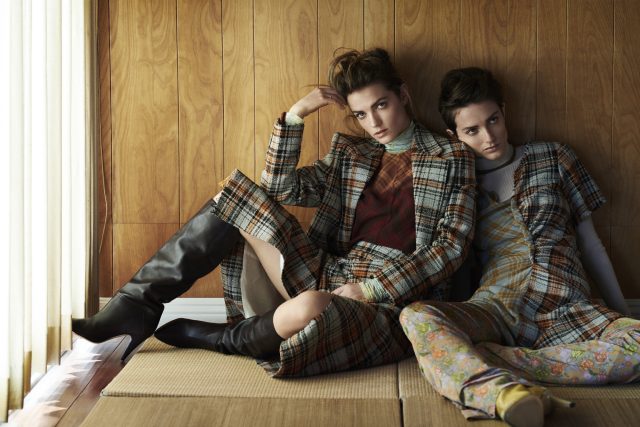 two women sitting on a floor