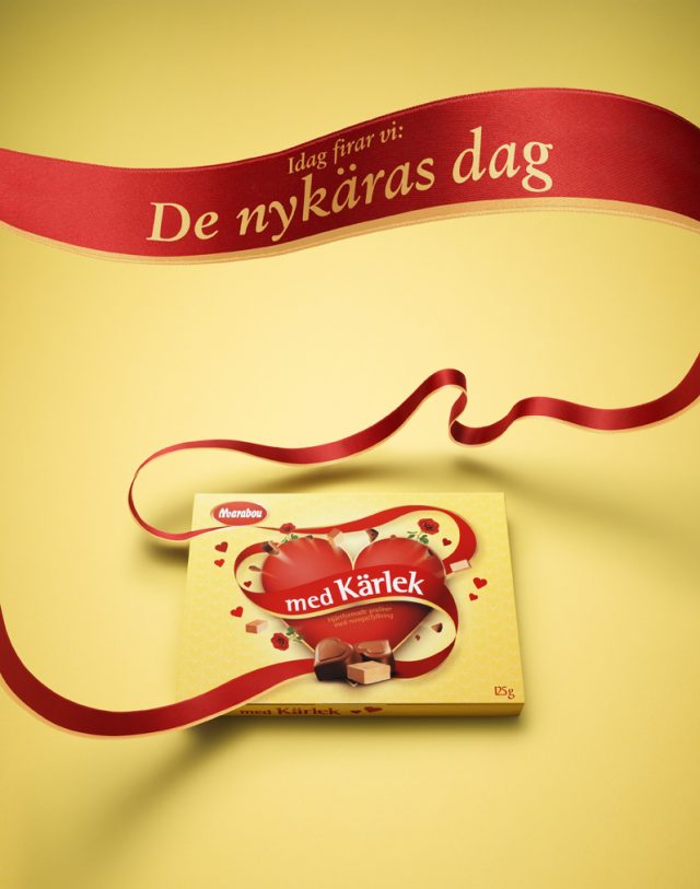a box of chocolate with a red ribbon