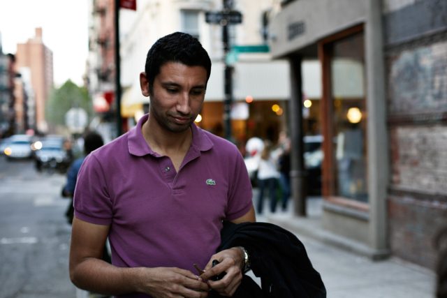 a man in a purple shirt
