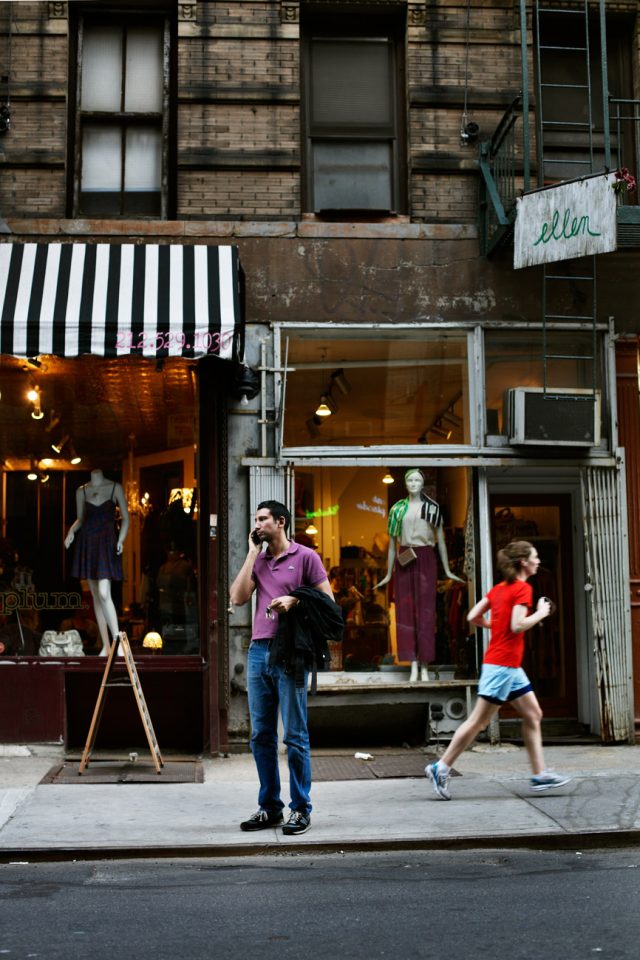 a man on the phone in front of a store
